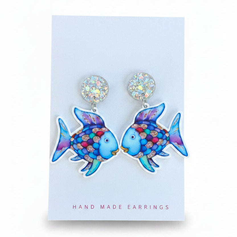 Pair of blue fish-shaped earrings on a card with &