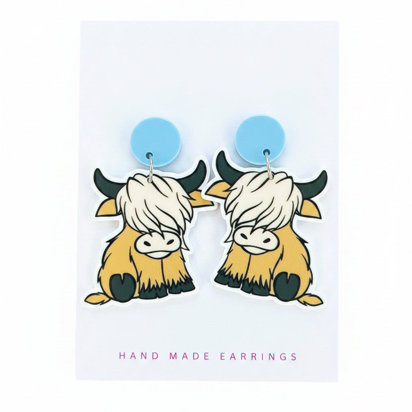 Earrings with cow design on a &