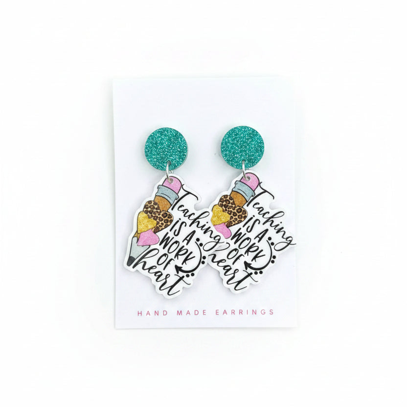 Turquoise glitter earrings on a card with &