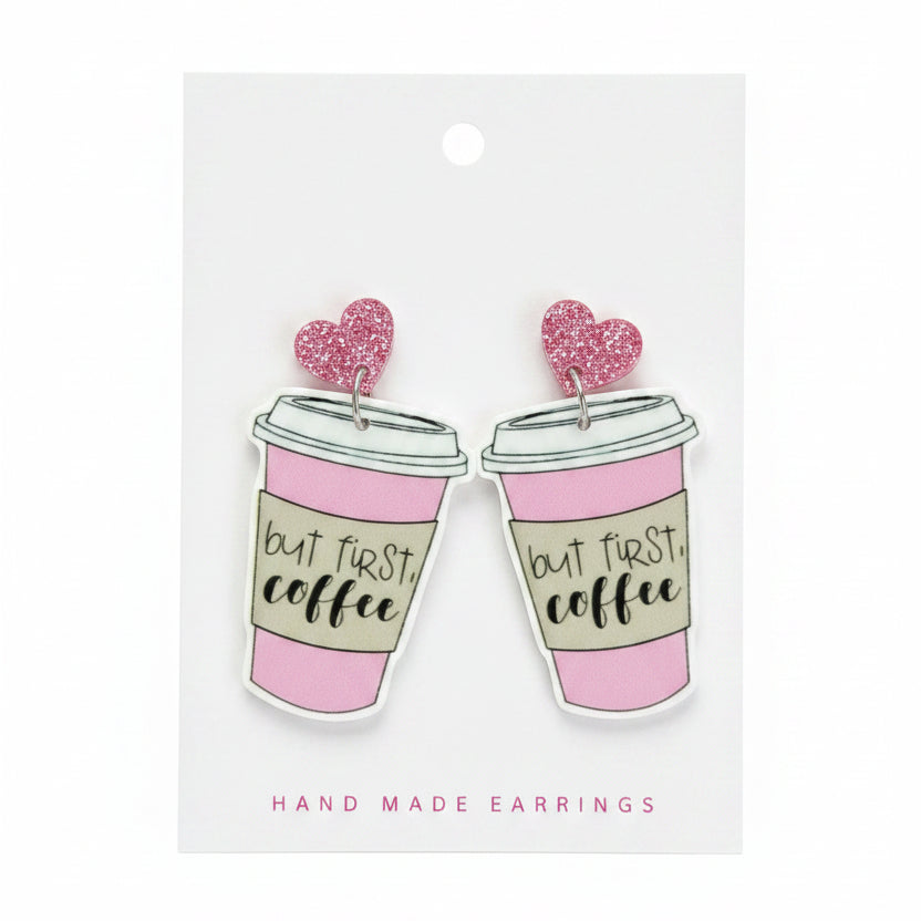 Pair of pink coffee cup earrings on a &