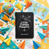 A black passport-style notebook or book cover with white airplane and globe illustrations and the text &